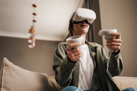 Excite White Woman Playing Online Game With Vr Glasses And Controllers