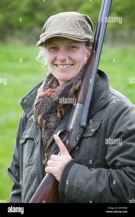 A Woman Wearing Shooting Clothing And Standing Outside In The English