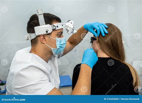 Ent Doctor Examines The Patientand X27s Ear Using An Otoscope Stock