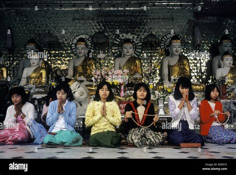 A Group Of Burmese Buddhist Women Pray At The Shwedagon Pagoda In