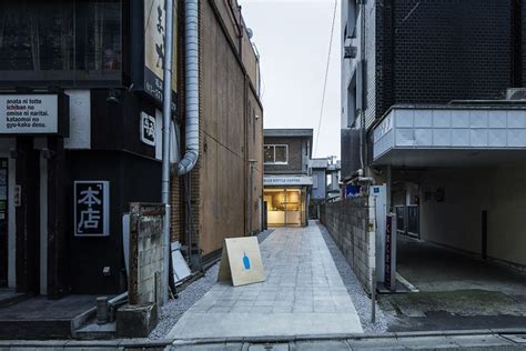 An Alley Way With Buildings And Signs On Both Sides In The Middle Of It