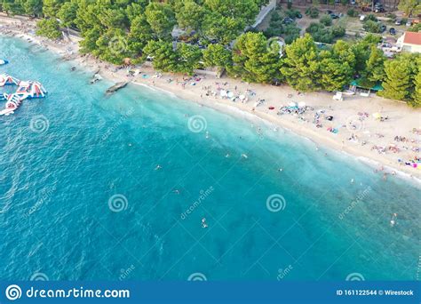 Aerial Shot Of People Enjoying The Beach Near Trees In Makarska