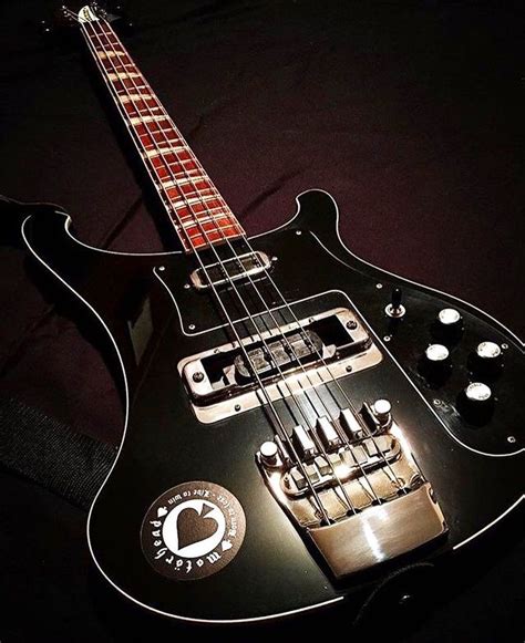 An Electric Bass Guitar Sitting On Top Of A Black Surface