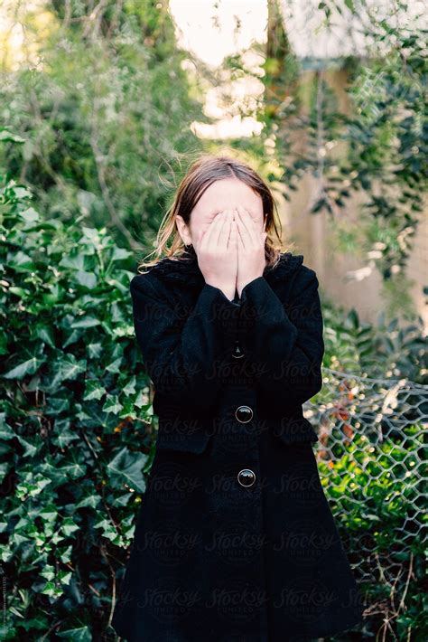 Tween Girl Covering Her Face With Her Hands By Stocksy Contributor