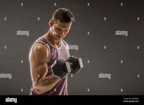 Muscular Man Doing Bicep Curl With Dumbbell Stock Photo Alamy
