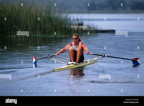 A Man Rowing A Single Scull Rowboat Stock Photo Alamy