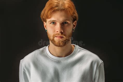 Portrait Of Serious Redhead Guy Isolated Over Black Background Stock