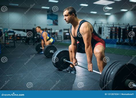 Two Weightlifters Doing Exercise With Barbells Stock Photo Image Of