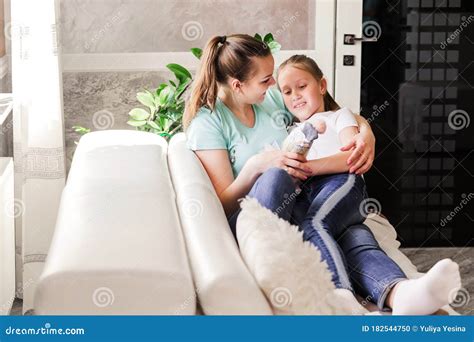Mother With Her Adult Daughter Sitting Together And Having Good Time In The Living Room In Front