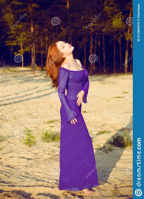 Woman In Purple Long Dress At Nature Fashionable Concept Stock Image