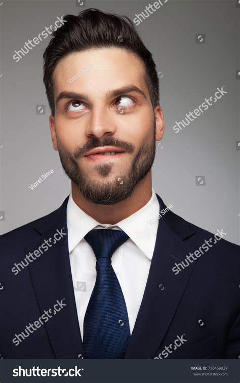 Young Cross Eyed Businessman Biting His Stock Photo 730459927