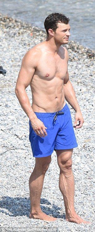 A Man In Blue Shorts Standing On The Beach