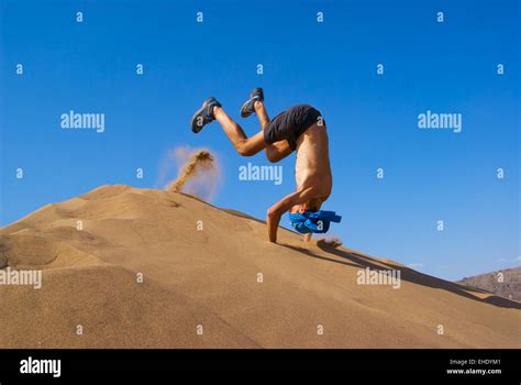 Fun Jumping On Sand Dune Stock Photo Alamy