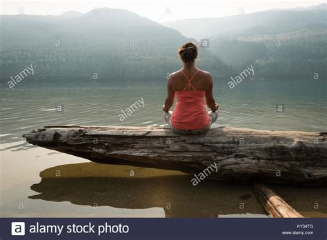 Female Meditating Lake High Resolution Stock Photography And Images Alamy