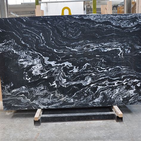 Large ivory and alabaster grains give this beautiful stone its dominant coloring, while russet and midnight blue veins add unique appeal. Nero Picasso Classic Marble Slab | Mazzmar Stone