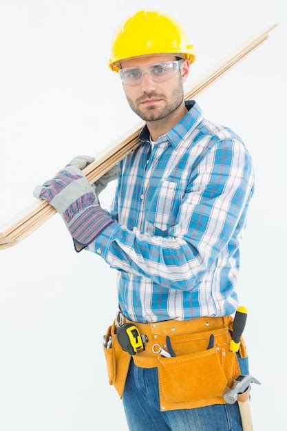 Premium Photo Construction Worker Carrying Wooden Planks