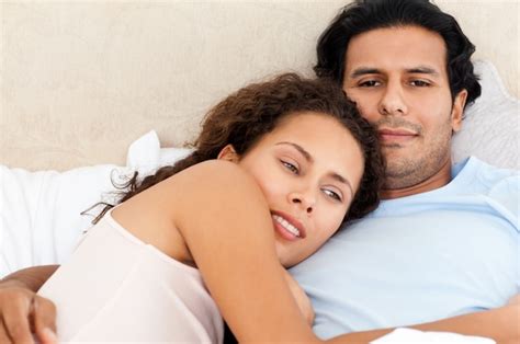 Premium Photo Portrait Of A Passionate Couple Lying Together On Their Bed