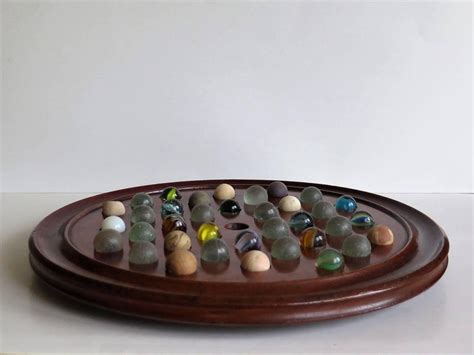 Please note that marbles may vary slightly from those seen here. Large 19th Century Table Marble Solitaire Board Game with 36 Marbles, Ca. 1860 at 1stdibs