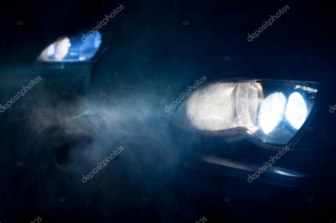 Car Headlights Of A Car At Night — Stock Photo © Svedoliver 18056397