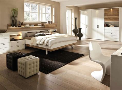 The bedroom is furnished with a double mattress with white sheets. Bedroom Designs