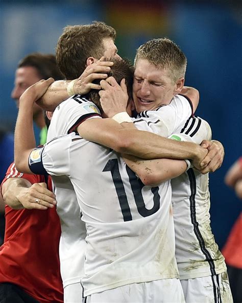 germany s thomas mueller left bastian schweinsteiger right and philipp lahm 16 embrace