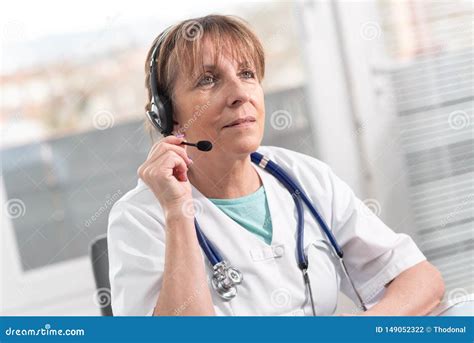 Portrait Of Female Doctor During Online Medical Consultation Stock