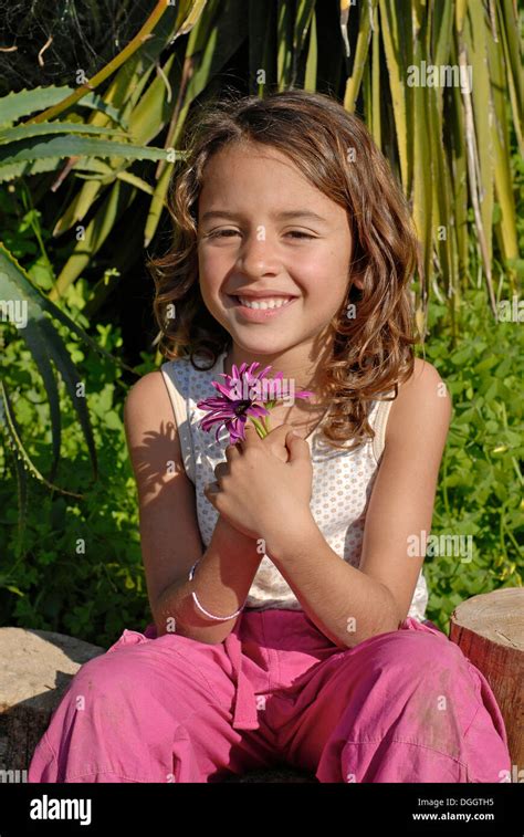 Cute Brazilian Six Year Old Girl Holding A Flower In Nature Stock Photo Alamy