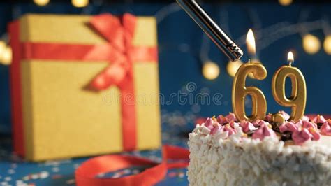 White Birthday Cake Number 69 Golden Candles Burning By Lighter Blue