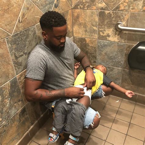Would you like to take care of a baby or do you just love babies? Dad Changes Son's Diaper on His Lap in Public Bathroom ...