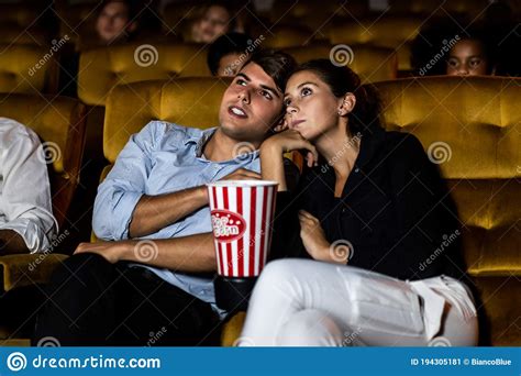 A Couple And Audience Watch A Movie In Theater Stock Image Image Of