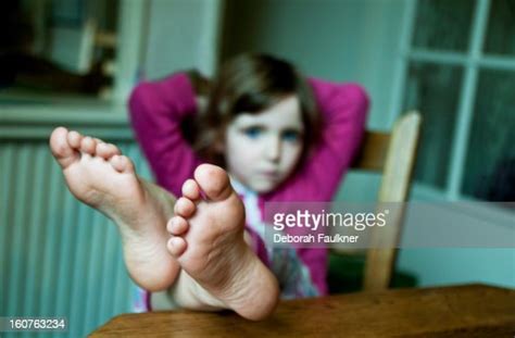 Small Girl With Feet On Table Photo Getty Images
