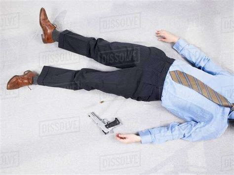 Man Lying On Floor With Gun Stock Photo Dissolve