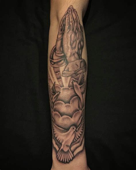 Grey Ink Winged Cross And Flying Dove In Hands Tattoo On Half Sleeve