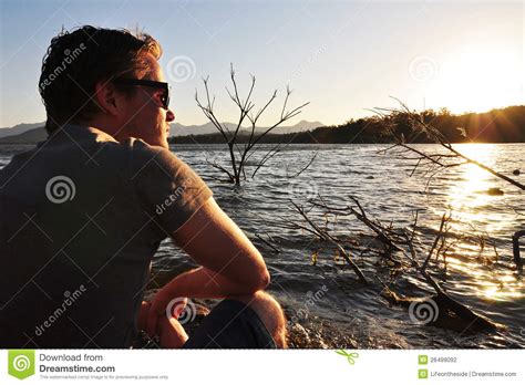 Young Man Sitting Quietly Beside Lake Stock Photo - Image of lonely ...