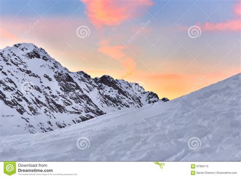 Beautiful View Of Mountain Peak With Sunset Light On Top Against Stock