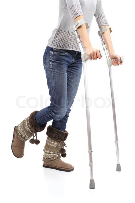 Close Up Of A Casual Woman Walking With Crutches Isolated