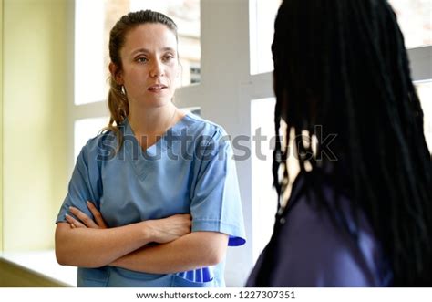 Nurses Having Conversation Hospital Hallway Stock Photo