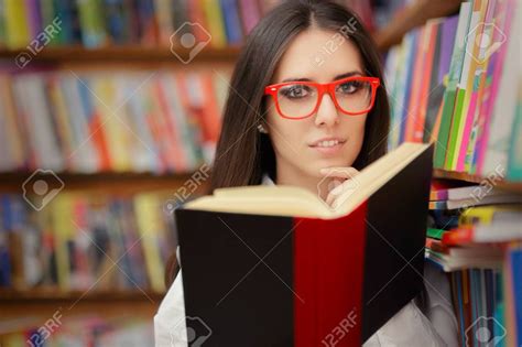Portrait Of A Woman With Red Eyeglasses Reading A Book In A Library