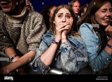 A Music Fan Gets Emotional Among The Concert Crowds At A Concert With