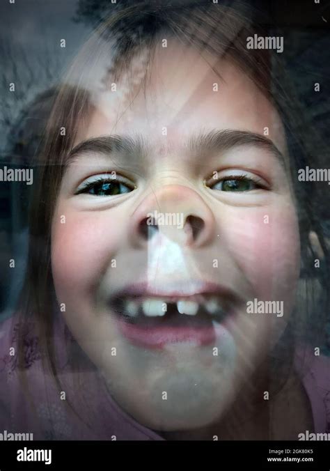 Childs Face Pressed Against Window Pane Looking Out Stock Photo Alamy