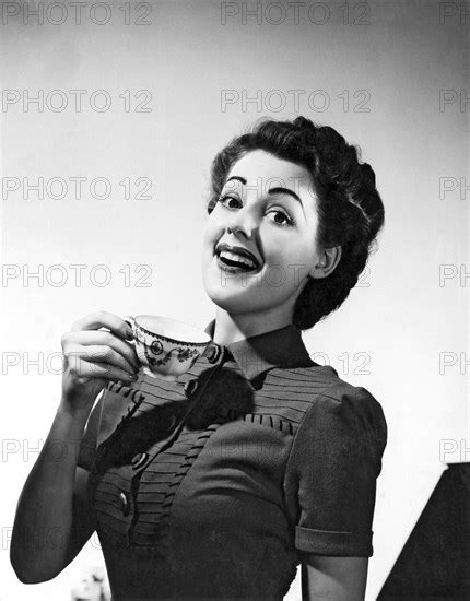 A Perky Woman Enjoys Her Cup Of Coffee Photo12 Underwood Archives Uig