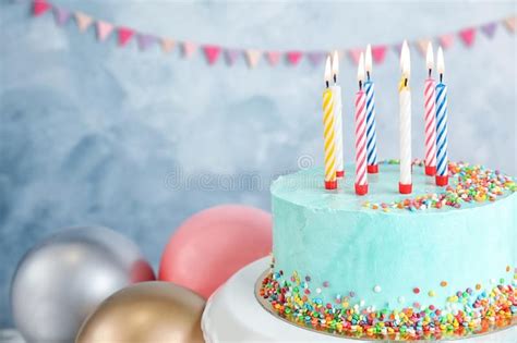 fresh delicious birthday cake with candles near balloons on color background sp … birthday