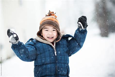 Asian Boy Playing Snow Outdoor In Winter By Stocksy Contributor Take