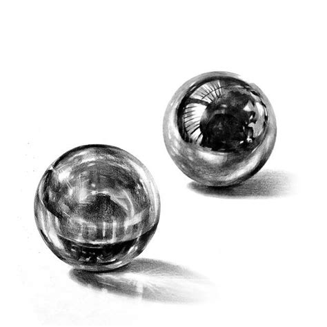Two Glass Balls Sitting Next To Each Other On A White Surface
