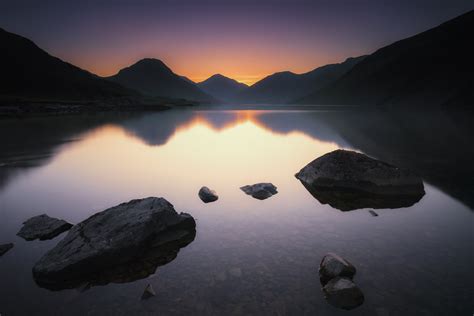 Gray Rocks On Body Of Water Surrounded By Mountains Hd Wallpaper