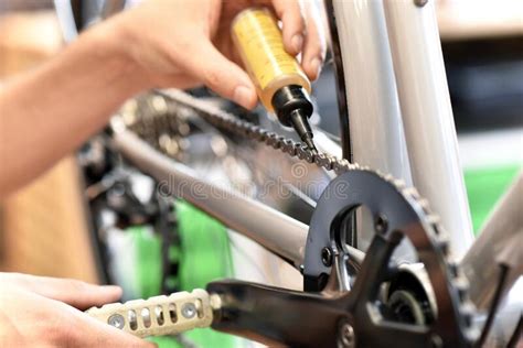 Friendly And Competent Bicycle Mechanic In A Workshop Repairs A Bike