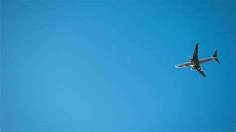 Flying Aeroplane On Light Blue Sky 4k 5k Hd Light Blue Wallpapers Hd