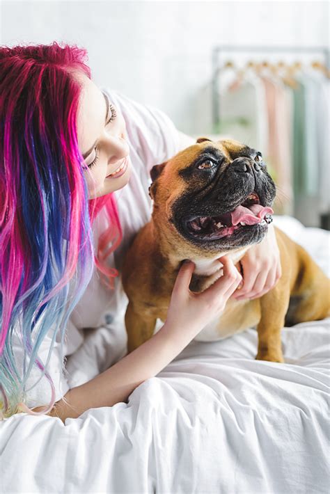 유토이미지 Girl With Colorful Hair Petting And Looking At Cute French Bulldog