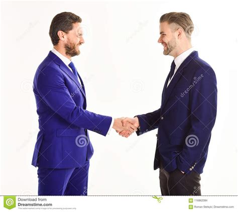 Men In Suits Or Businessmen Hold Hands In Handshake Stock Photo