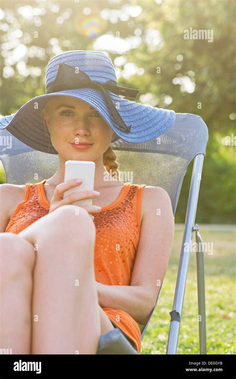 Woman Sitting Outdoors Chair Using Cell Phone Hi Res Stock Photography